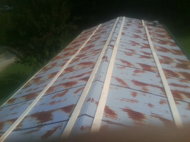 Rusted metal roof panels with new wood purlins before replacement — Storm Damage Roof Repair in Brinkhaven by Roofing Brothers